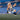 Gnome figure in a blue and white sports jersey pointing towards the camera on a blurred stadium background.